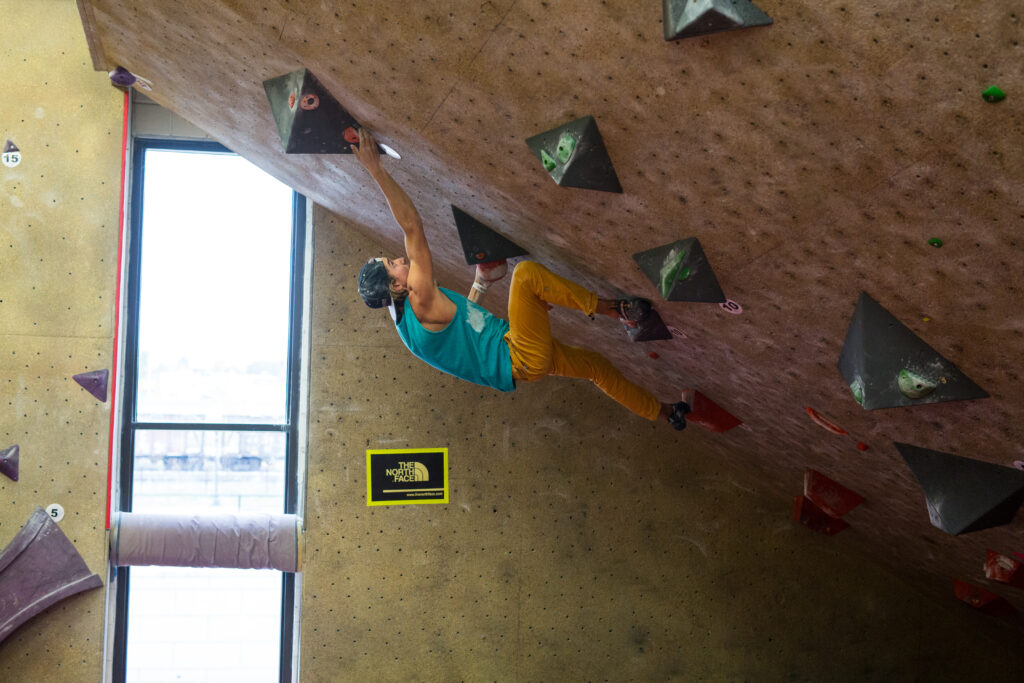 man bouldering in steep cave at vertical endeavors st paul