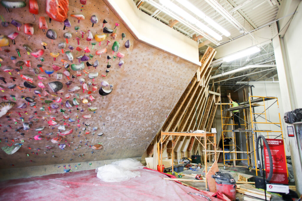 a bouldering wall under construction while additions are made